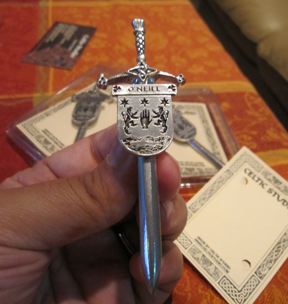 Photograph of a kilt pin with the O'Neill family crest on it.
